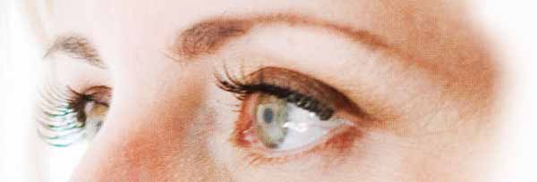 close-up of a woman's eyes focused clearly on objective